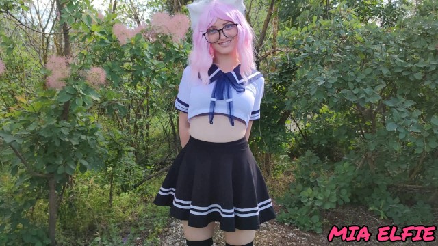 Sexy schoolgirl with ears in uniform walks down the abandoned road